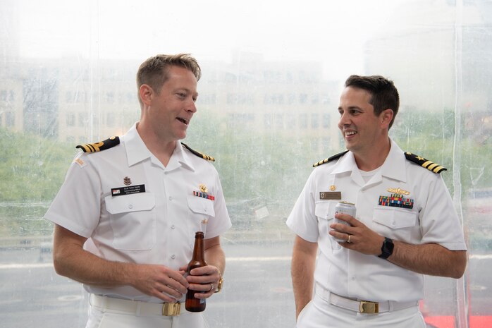 Lt. Cmdr. Tyler Smith, commanding officer, assigned to Royal Canadian Navy Kingston-class coastal defense vessel, HMCS Edmonton, speaks with Cmdr. Joseph Gunta, commanding officer, assigned to Arleigh Burke-class guided-missile destroyer, USS John S. McCain (DDG 56), at an U.S. Navy reception during Portland Fleet Week in Portland, Oregon, June 9, 2023. Portland Fleet Week is a time-honored celebration of the sea services and provides an opportunity for the citizens of Oregon to meet Sailors, Marines and Coast Guardsmen, as well as witness firsthand the latest capabilities of today’s maritime services. (U.S. Navy photo by Mass Communication Specialist Seaman Sophia H. Bumps)