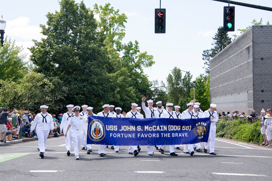 Sailors assigned to Arleigh Burke-class guided-missile destroyer, USS John S. McCain (DDG 56), march  together at the annual Rose Festival Parade during Portland Fleet Week in Portland, Oregon, June 10, 2023. Portland Fleet Week is a time-honored celebration of the sea services and provides an opportunity for the citizens of Oregon to meet Sailors, Marines and Coast Guardsmen, as well as witness firsthand the latest capabilities of today's maritime services. (U.S. Navy photo by Mass Communication Specialist Seaman Sophia H. Bumps)