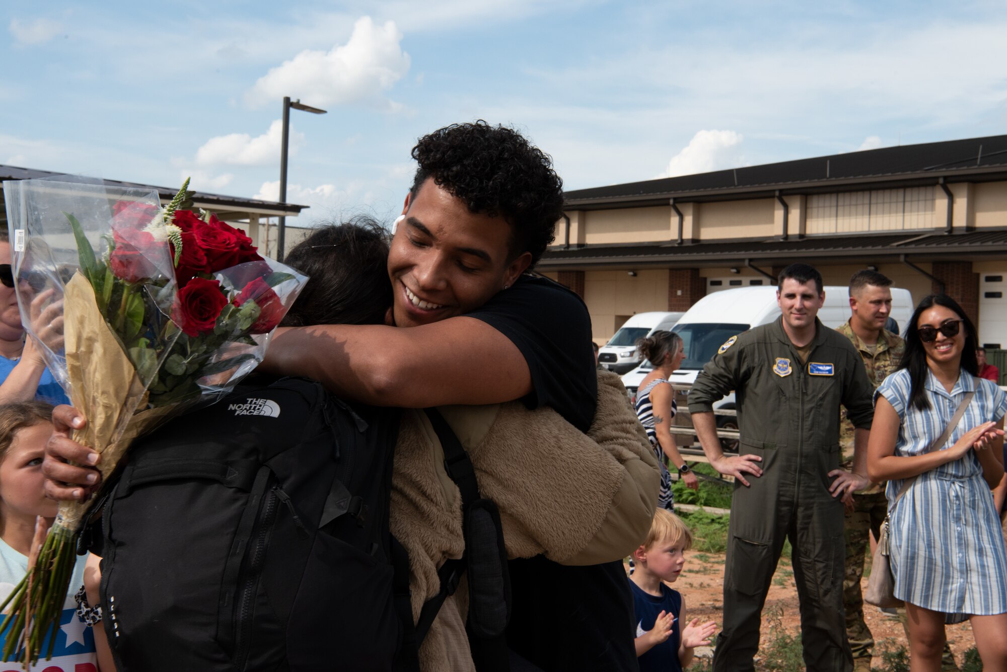 A U.S. Air Force Airman from the 317th Airlift Wing embraces a family member while returning from a six-month deployment at Dyess Air Force Base, Texas, June 7, 2023. The 317th AW leadership and family members gathered to welcome home the Airmen after their return from supporting U.S. Central Command taskings. (U.S. Air Force photo by Airman 1st Class Alondra Cristobal Hernandez)
