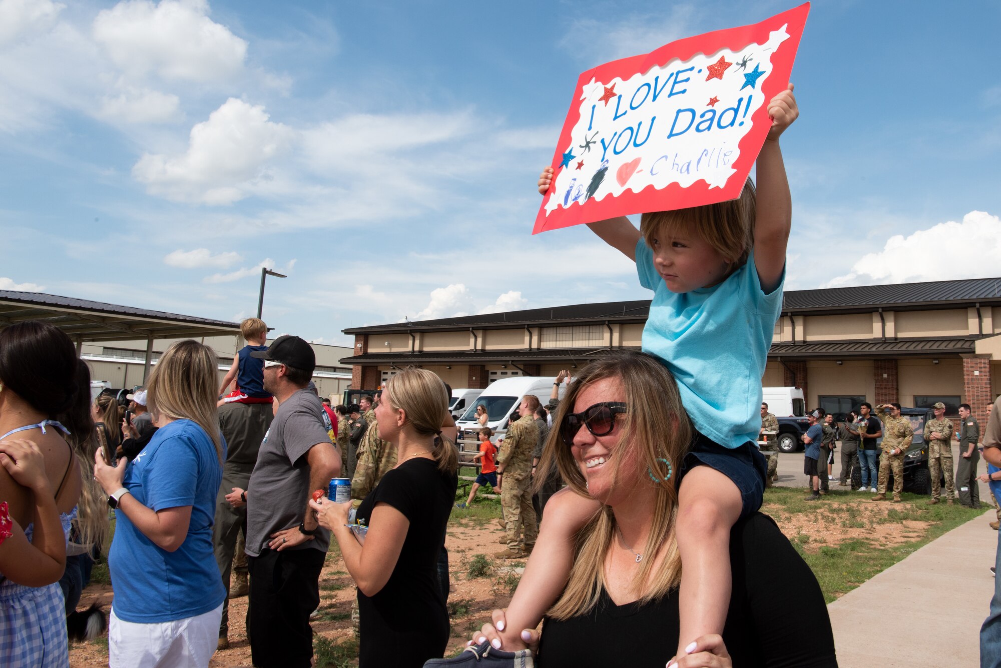 Family members welcome home U.S. Air Force Airmen from the 317th Airlift Wing returning from a six-month deployment at Dyess Air Force Base, Texas, June 7, 2023. The 317th AW leadership and family members gathered to welcome home the Airmen after their return from supporting U.S. Central Command taskings. (U.S. Air Force photo by Airman 1st Class Alondra Cristobal Hernandez)