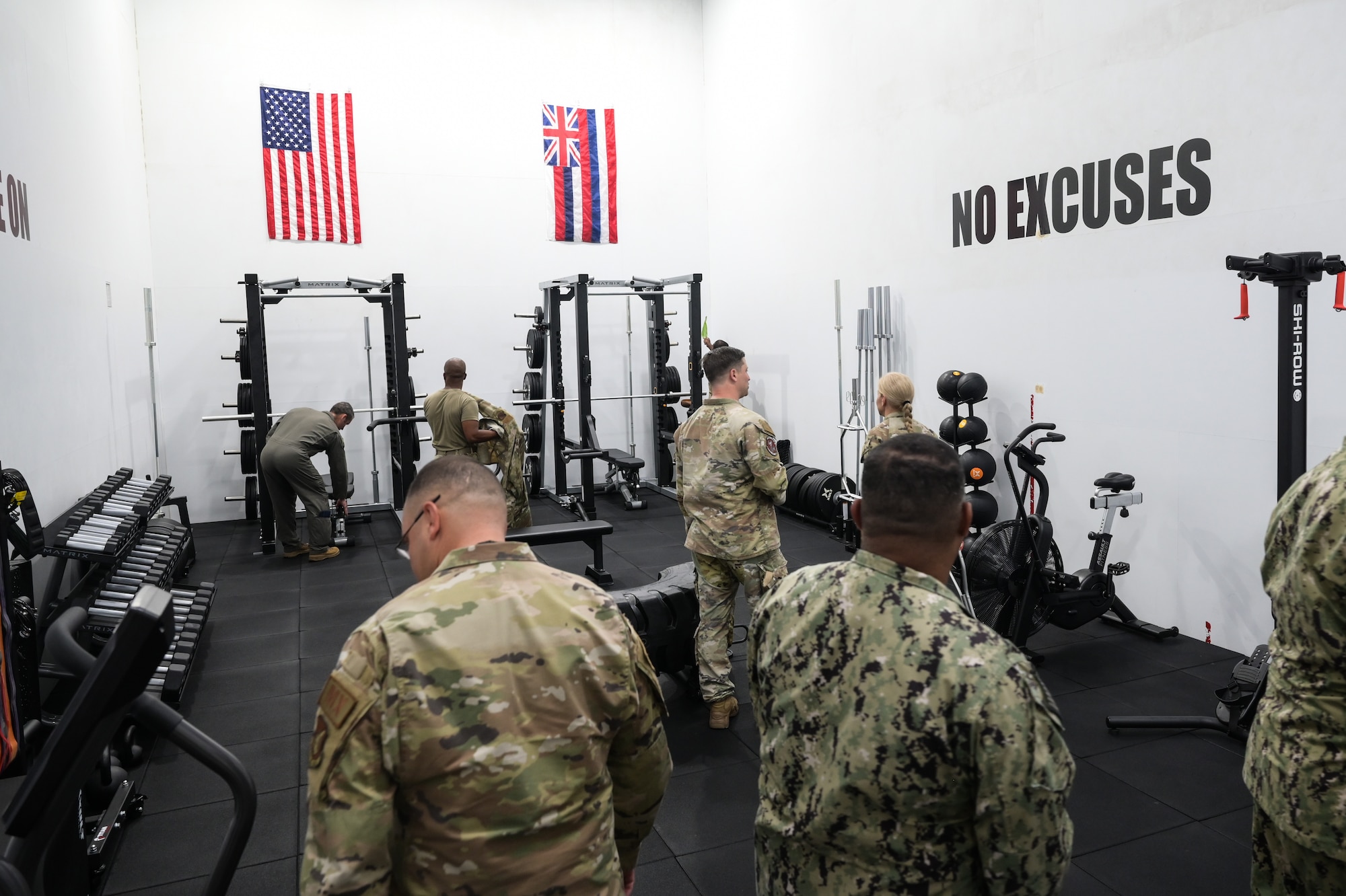 Joint Base Pearl Harbor-Hickam, 15th Wing and 647th Force Support Squadron leadership familiarize themselves with equipment in the new functional fitness room at the Hickam Memorial Fitness Center on Joint Base Pearl Harbor-Hickam, Hawaii, Jun. 6, 2023. The purpose of the room is to provide servicemembers with updated equipment, ensuring they have the means to maintain their physical and mental fitness. (U.S. Air Force photo by Staff Sgt. Alan Ricker)