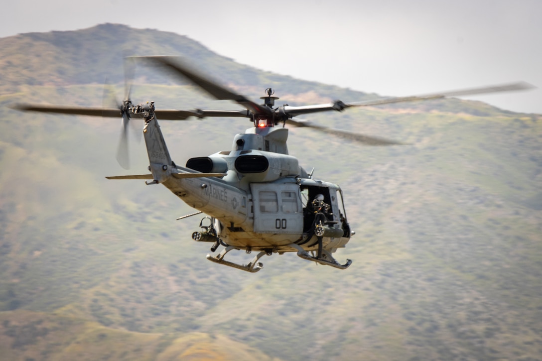 A U.S. Marine Corps UH-1Y Venom, with Light Attack Helicopter Squadron 367, Marine Aircraft Group 39, 3rd Marine Aircraft Wing, flys over the training area during a close air support exercise as part of United Arab Emirates Unit Enhancement Training at Marine Corps Base Camp Pendleton, California, May 11, 2023. The intent of UAE Unit Enhancement Training is to further develop and reinforce partner relations and enhance United Arab Emirates soldiers knowledge of Marine Corps tactics and procedures in indirect fire and close air support.