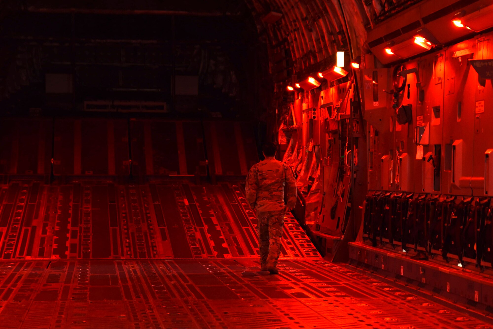 U.S. Air Force Senior Airman Eddie Peña-Suarez, loadmaster with the 4th Airlift Squadron, runs a function test before take-off during a local training mission at Joint Base Lewis-McChord, Washington, May 31, 2023. The training included wet-wing defueling a process that removes fuel from a C-17 Globemaster III and transfers it to an R-11 aircraft refueling truck while the engines are still running to decrease ground time. (U.S. Air Force photo by Airman 1st Class Kylee Tyus)