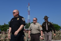 Minot Police Department prepares to give a speech for National Police Week June 5, 2023 at Minot Air Force Base, North Dakota. Speakers at the opening ceremony included members from the 5th Security  Forces Squadron, 91st Security Forces Group, City of Minot Police Department, and Col. Daniel S. Hoadley, commander of the 5th Bomb Wing.  (U.S. Air Force photo by Airman 1st Class Trust Tate)