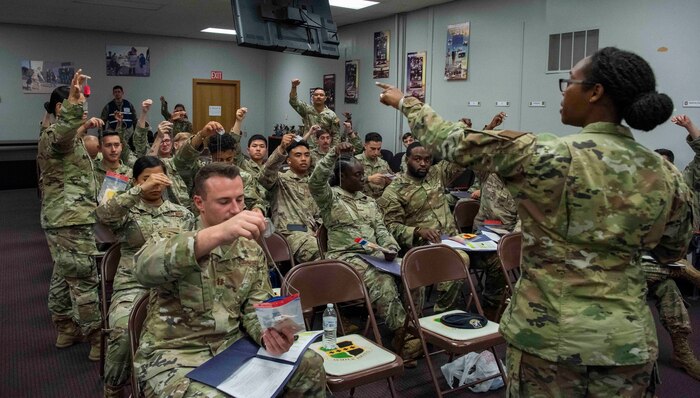 Airmen hold up dog tags