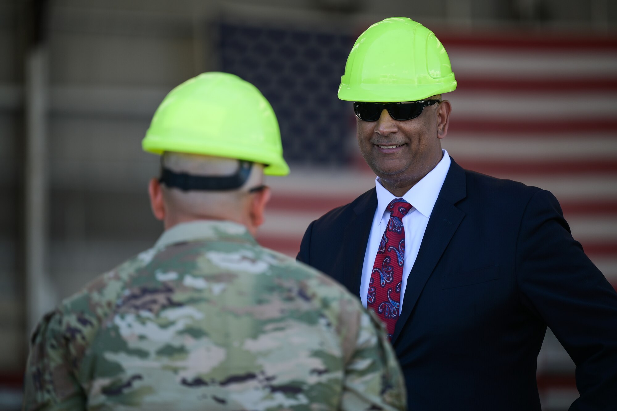 The Honorable Ravi Chaudhary, Assistant Secretary of the Air Force for Energy, Installations, and Environment, speaks to 2nd Lt. Jason De La Mora, 15th Maintenance Squadron fabrications flight commander, during a tour of the 15th Wing on Joint Base Pearl Harbor-Hickam, Hawaii, Jun. 6, 2023. Chaudhary was introduced to the requirements maintenance personnel are required to take to ensure their airmen are safe and that they are able to support incoming and outgoing missions. (U.S. Air Force photo by Staff Sgt. Alan Ricker)