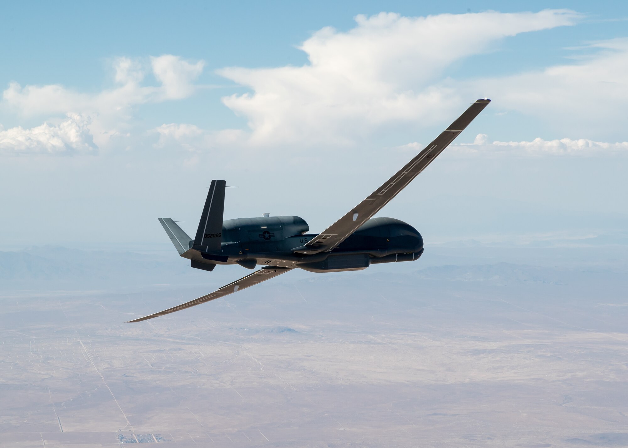 An RQ-4 Global Hawk assigned to the 452nd Flight Test Squadron flies in the skies above Edwards Air Force Base, California, May 23.The 452nd FLTS held a “sunsetting” event for the RQ-4 Global Hawk flight test program at Edwards AFB, June 9. The event marked the completion of the squadron’s test campaign for the aircraft. (Air Force photo by Bryce Bennett)