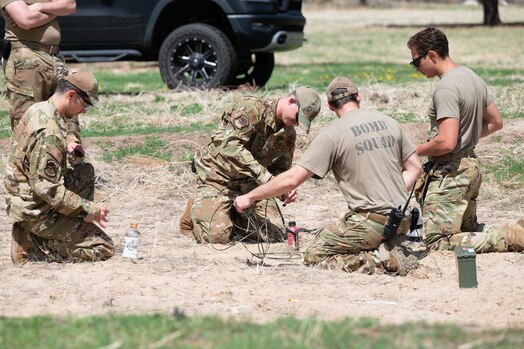  PETERSON SPACE FORCE BASE, Colo. – U.S. Air Force Tech. Sgt. Chris Camille, second from right, an Explosive Ordnance Disposal team lead from the 21st Civil Engineering Squadron, trains EOD Airmen on improvised mitigation techniques using water in bottles on Peterson Space Force Base, Colorado, May 25, 2023. The EOD are preeminent tactical and technical explosives experts in place to protect the base and its assets. (U.S. Space Force photo by Airman 1st Class Justin Todd)