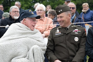 U.S. Army Maj. Gen. Todd R. Wasmund, the commanding general of the U.S. Army Southern European Task Force Africa (SETAF-AF), converses with U.S. Marine Corps veteran Don Graves, assigned to the 5th Marine Division - Iwo Jima, in Nehou, France, June 3, 2023. Big Red One Soldiers and representatives of sister divisions toured historical landmarks and monuments dedicated to the units that landed and fought on D-Day. (U.S. Army photo by Pfc. Dawson Smith)