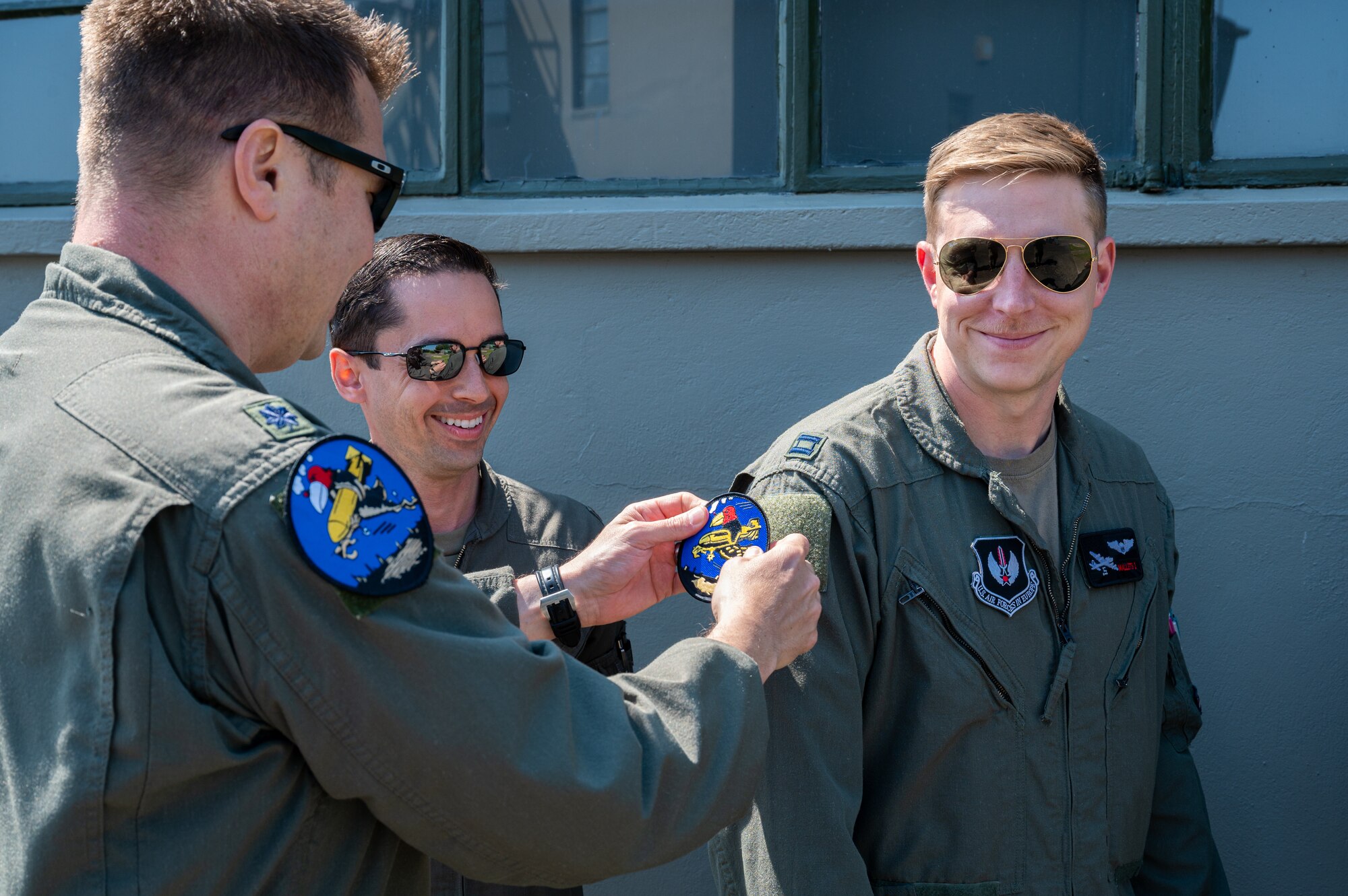 U.S. Air Force Lt. Col. Tyler Berge, left, 351st Air Refueling Squadron commander, presents the squadron heritage “Buzzard” patch to Capt. Zach Mallets, 351st ARS flight commander, at the 100th Bomb Group Memorial Museum, Thorpe Abbotts, England, June 9, 2023.
