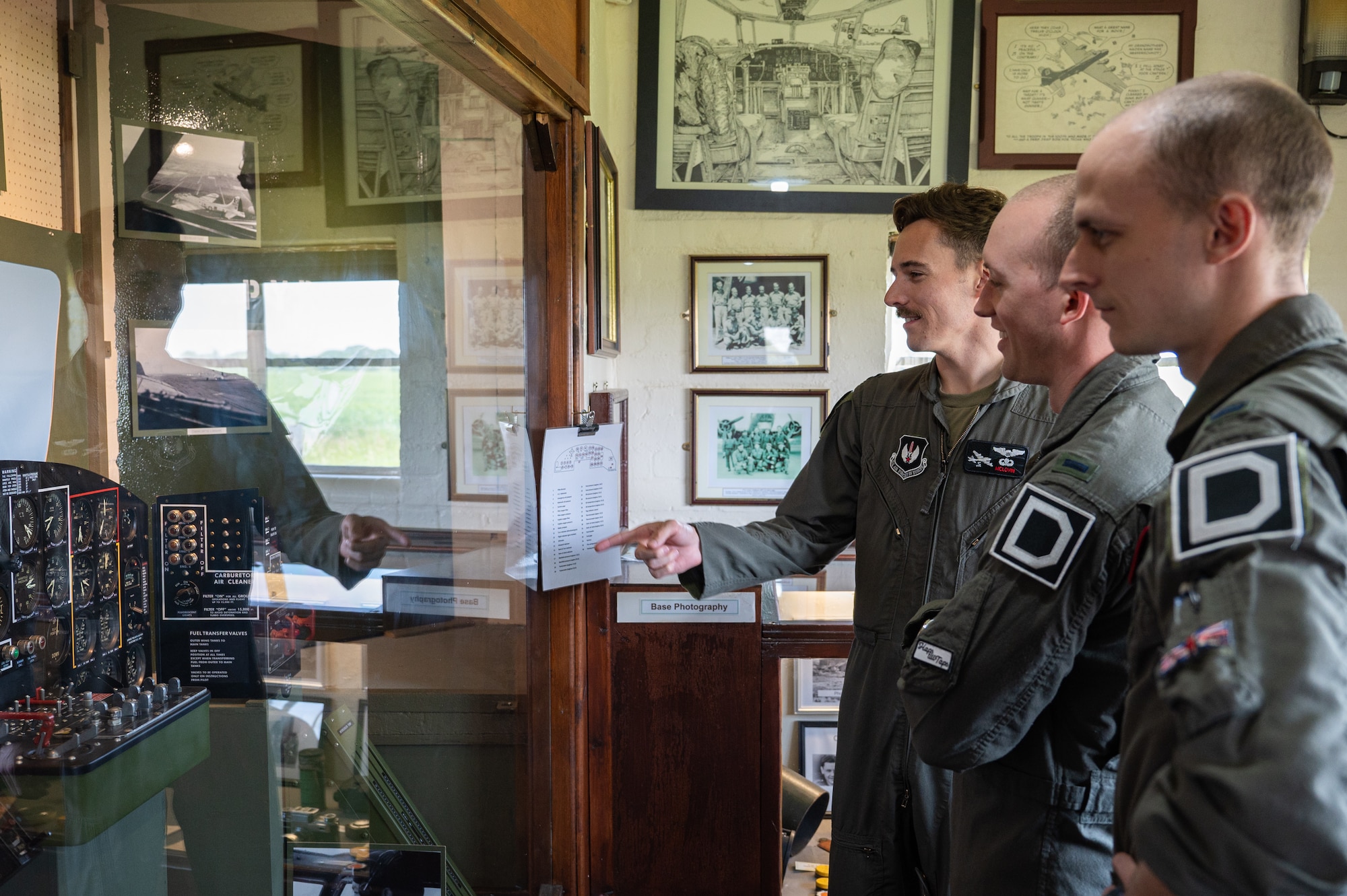 U.S. Air Force Airmen assigned to the 351st Air Refueling Squadron look at a display at the 100th Bomb Group Memorial Museum, Thorpe Abbotts, England, June 9, 2023.