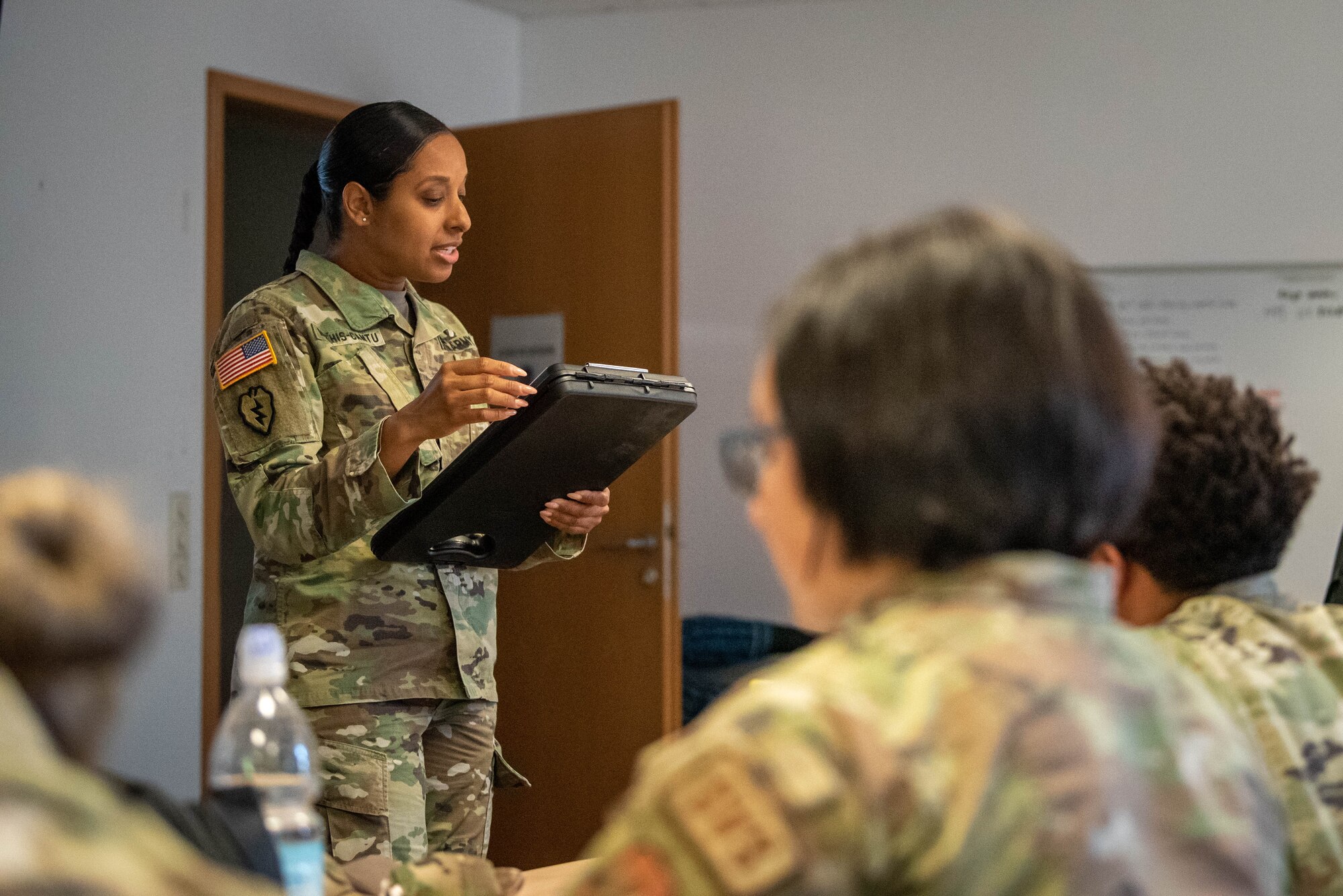 U.S. Army Sgt. 1st Class Denetra Mathis-Cantu, 16th Sustainment Brigade senior mortuary affairs non-commissioned officer, gives a simulated Search and Recovery mission brief to Airmen from the 52nd and 786th Force Support Squadrons on Ramstein Air Base, Germany.