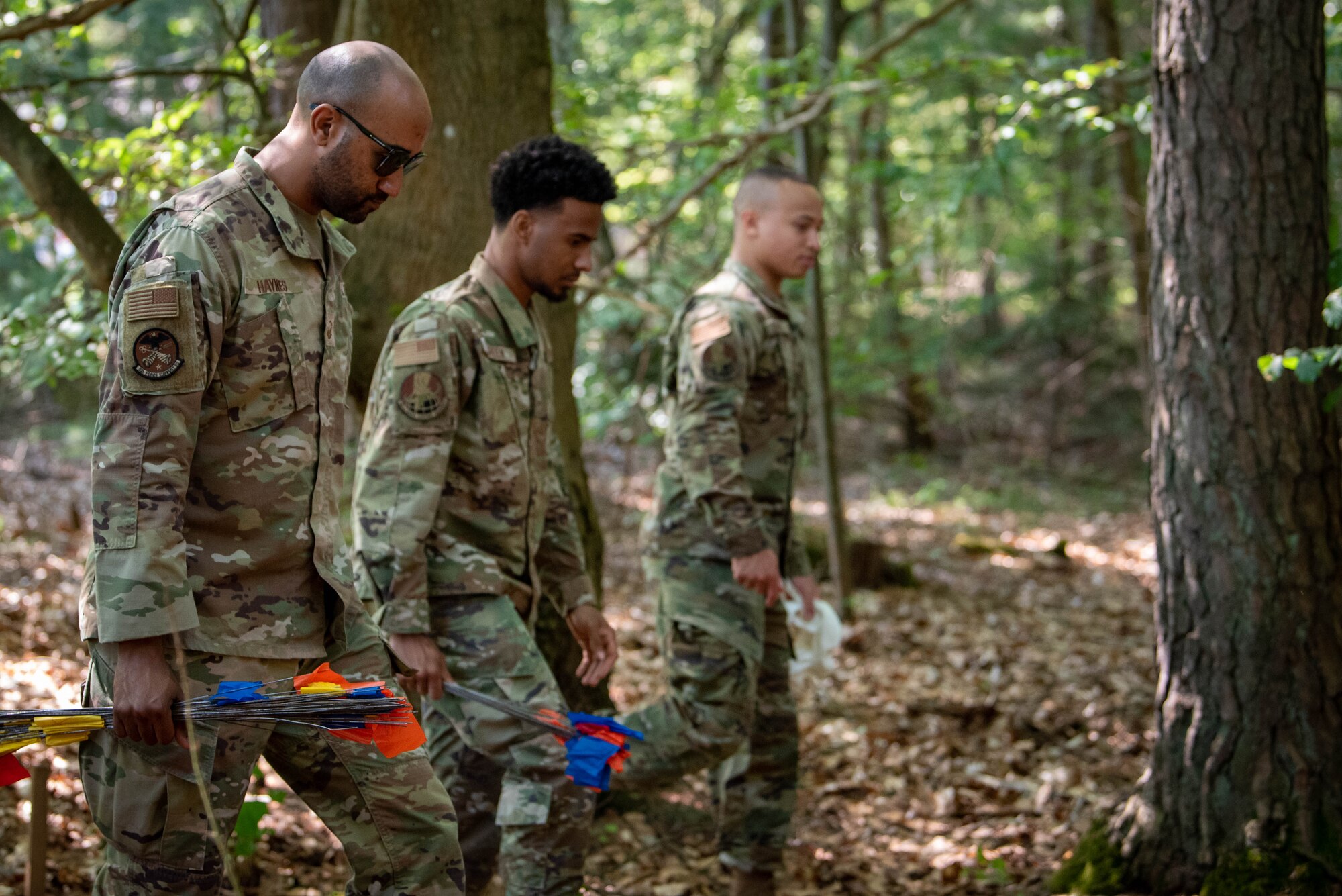 U.S. Air Force airmen from the 52nd Force Support Squadron and the 786th Force Support Squadron search the exercise area during a Search and Recover training exercise on Ramstein Air Base, Germany.