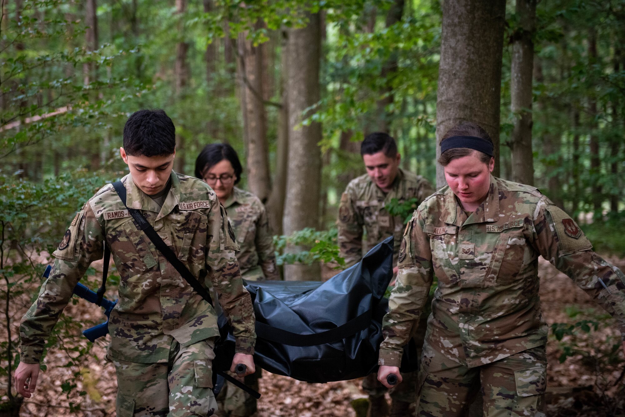 U.S. Air Force members from the 52nd and 786th Force Support Squadrons carry simulated human remains out of the exercise area during a search and recovery exercise on Ramstein Air Base, Germany.