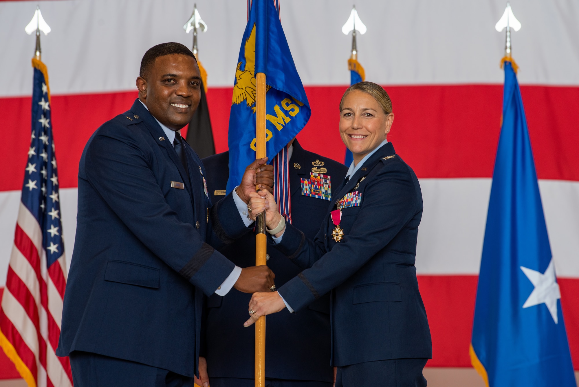 U.S. Air Force Brig. Gen. Otis C. Jones, 86th Airlift Wing commander, presents the guidon to Col. Amy M. Glisson, outgoing 86th Mission Support Group commander, at Ramstein Air Base, Germany, June 9, 2023.