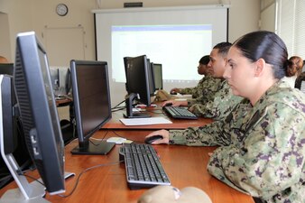 230517-N-YR423-6340 PENSACOLA, Fla. (May 17, 2023) - Fleet Subject Matter Experts from the Navy Counselor (Counselor) Advancement Examination Readiness Review (AERR) review reference material  as they develop content for the Navy-wide advancement exam for their rating. (U.S. Navy photo by Cheryl Dengler)