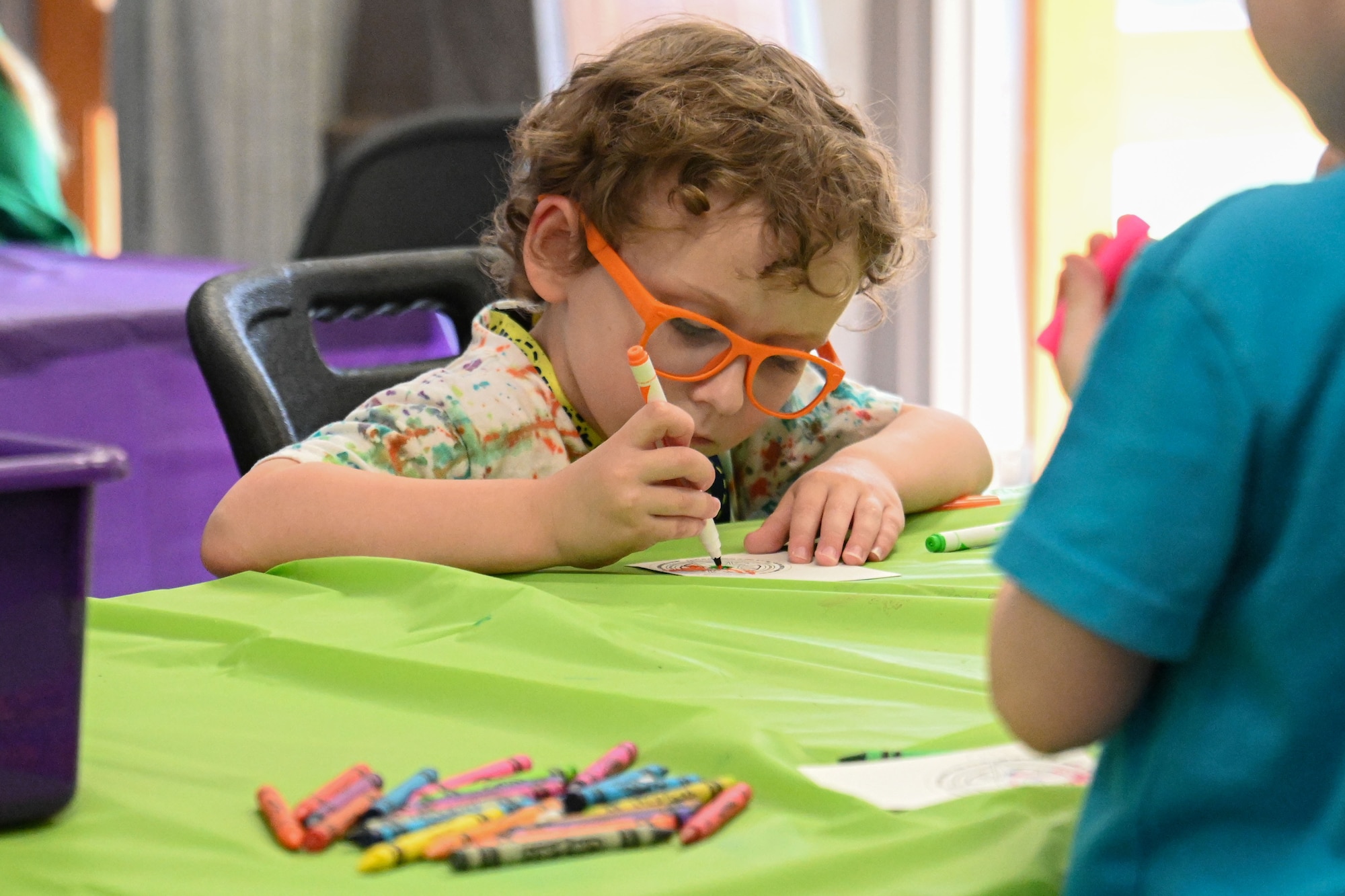 a child colors a craft