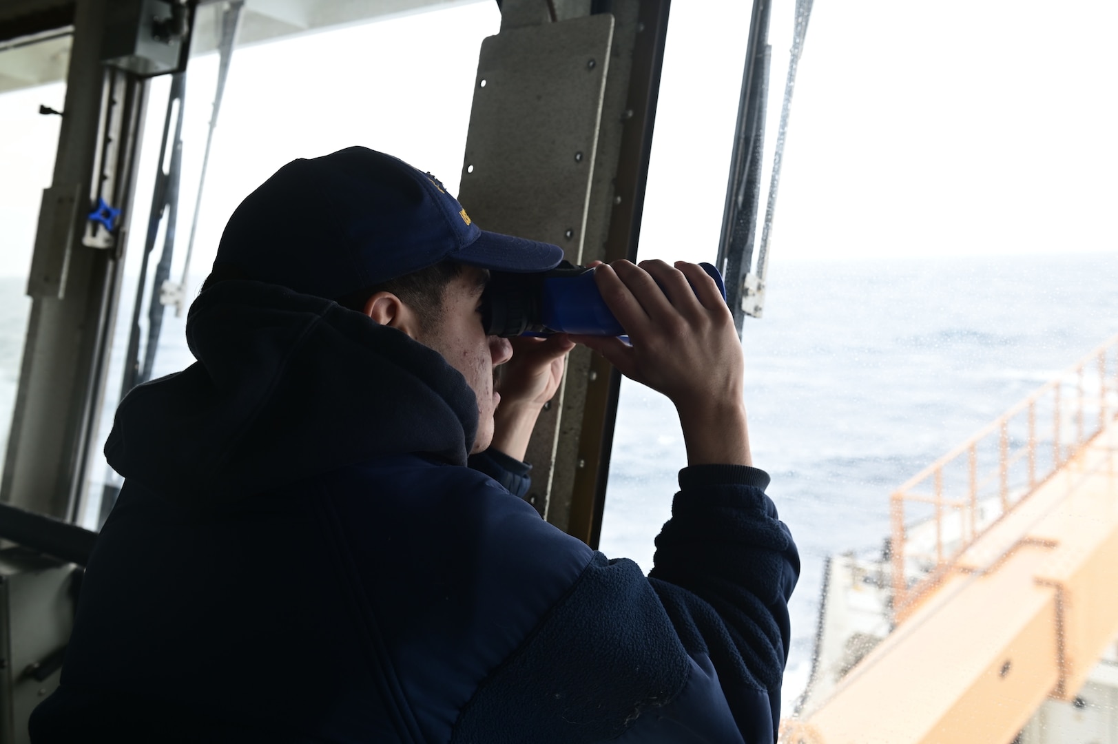 U.S. Coast Guard Seaman Jerry Cook stands lookout watch on the bridge of USCGC Sycamore (WLB 209) while en route to Exercise Argus, North Atlantic Ocean, June 2, 2023. Exercise Argus is a joint search and rescue and marine environmental response exercise that includes assets from the United States, Denmark, Greenland, and France. (U.S. Coast Guard photo by Petty Officer 2nd Class Ryan Schultz)