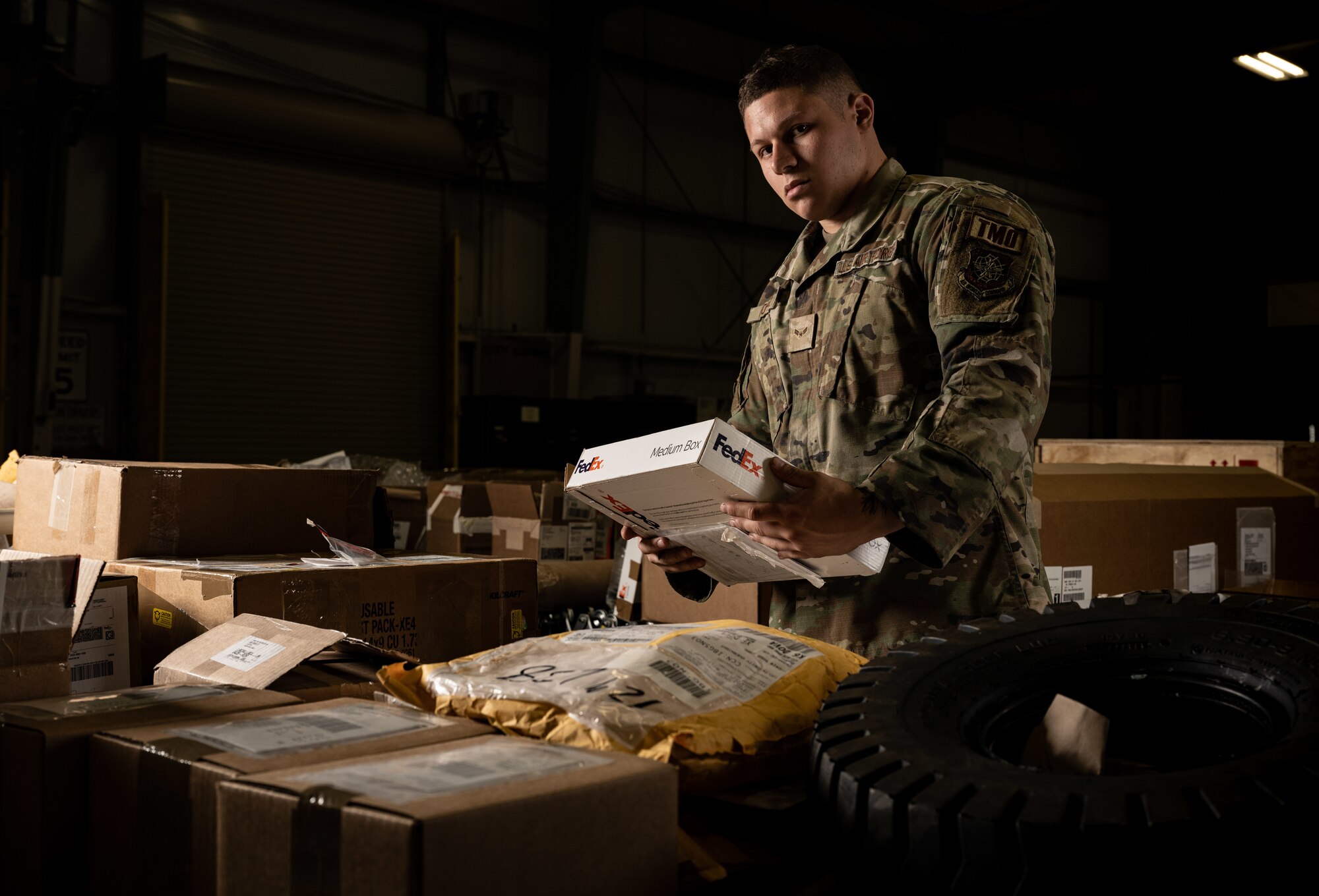 Airman 1st Class Santos Lopez, 436th Aerial Port Squadron inbound cargo specialist, opens a package at Dover Air Force Base, Delaware, May 9, 2023. Packages arriving by commercial carriers are sorted by priority and shipping documents are validated against contents and for correctness. (U.S. Air Force photo by Staff Sgt. Marco A. Gomez)