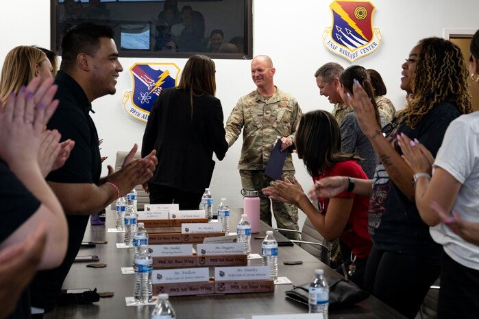 U.S. Air Force Col. Joshua DeMotts, right, 99th Air Base Wing commander, greets Yolanda Fargas, Las Vegas Aces president, before a mission brief at Nellis Air Force Base, Nevada, June 9, 2023.