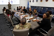 The Las Vegas Aces leadership team receives a mission brief before a base tour at Nellis Air Force Base (AFB), Nevada, June 9, 2023.