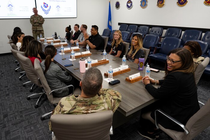 The Las Vegas Aces leadership team receives a mission brief before a base tour at Nellis Air Force Base (AFB), Nevada, June 9, 2023.