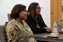 U.S. Air Force Chief Master Sgt. Adrienne Warren, left, 99th Air Base Wing command chief, and Yolanda Fargas, Las Vegas Aces president listen to a mission brief at Nellis Air Force Base (AFB), Nevada, June 9, 2023.