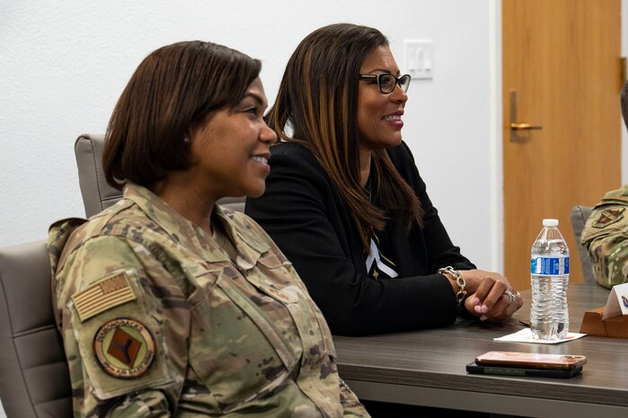 U.S. Air Force Chief Master Sgt. Adrienne Warren, left, 99th Air Base Wing command chief, and Yolanda Fargas, Las Vegas Aces president listen to a mission brief at Nellis Air Force Base (AFB), Nevada, June 9, 2023.