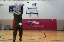 BUCKET$, the Las Vegas Aces mascot, plays basketball in the Warrior Fitness Center, at Nellis Air Force Base, Nevada, June 9, 3023.