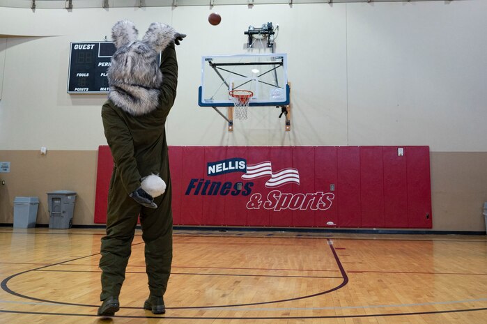 BUCKET$, the Las Vegas Aces mascot, plays basketball in the Warrior Fitness Center, at Nellis Air Force Base, Nevada, June 9, 3023.