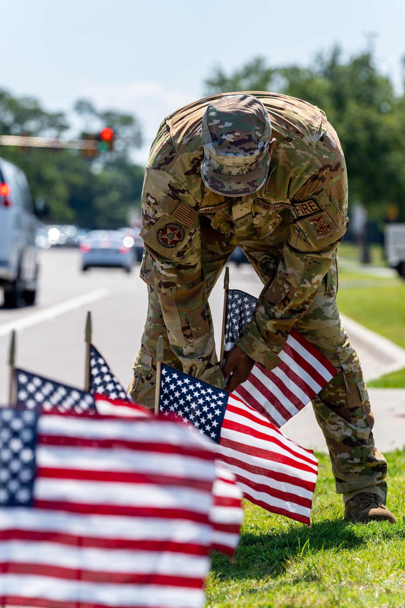 U.S. Air Force Tech. Sgt. Anthony Marshall, 81st Civil Engineer Squadron chief of health and safety, places flags at Keesler Air Force Base, Mississippi, June 12, 2023.
