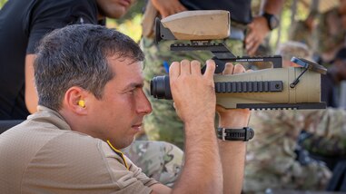 A Fuerzas Comando competitor from the 7th Special Forces Group uses a range finder at the range, June, 12, 2023 in Sierra Prieta, Santo Domingo.