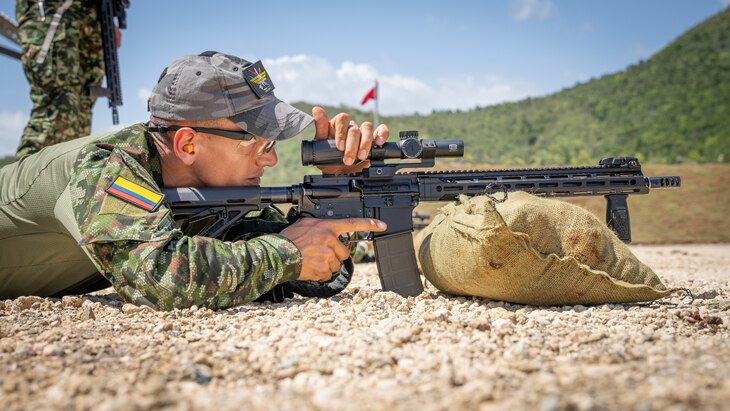 A Fuerzas Comando competitor sights-in his scope at the range, June, 12, 2023 in Sierra Prieta, Santo Domingo.