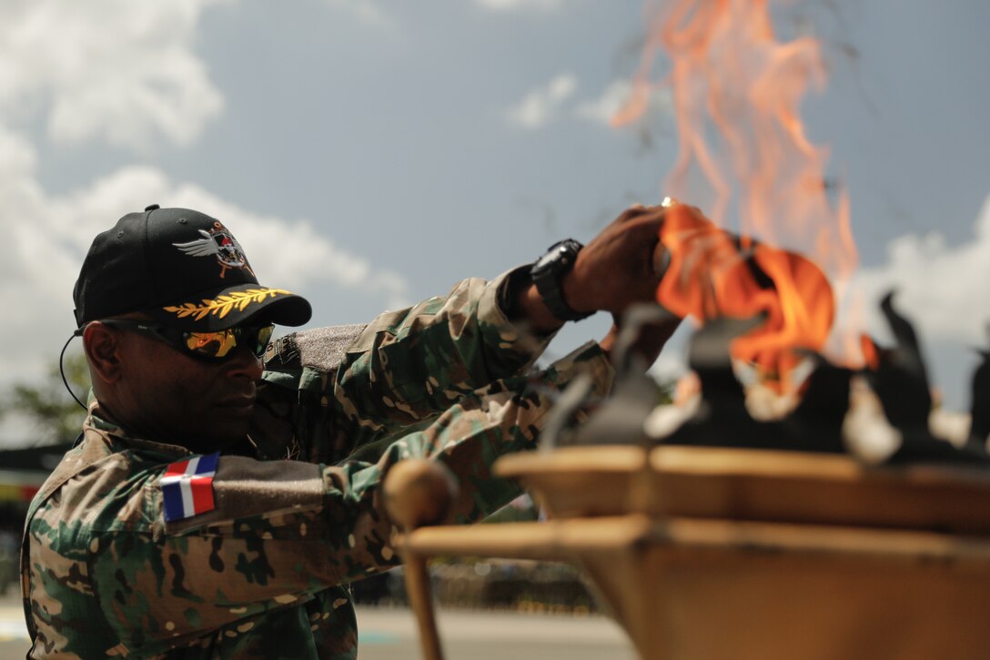 A Dominican Republic soldier lights the torch at the opening ceremony for Fuerzas Comando 23 at Santo Domingo, Dominican Republic, June 12 2023.
