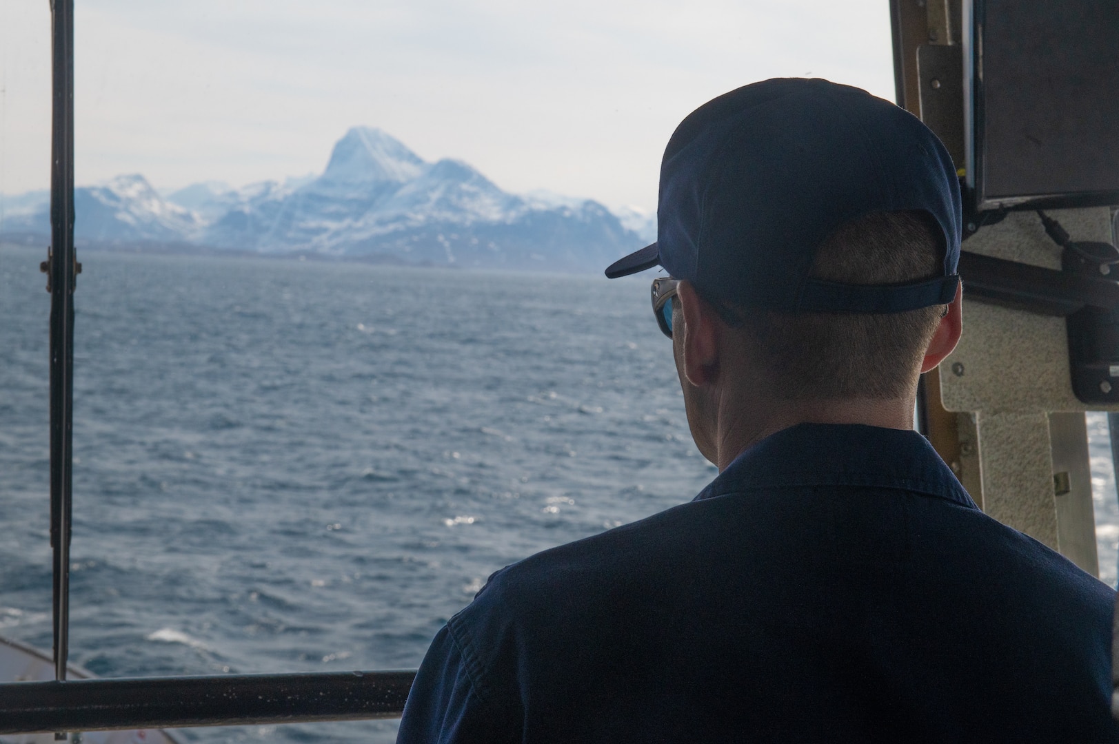 U.S. Coast Guard Cmdr. Chad Conrad, the commanding officer of USCGC Sycamore (WLB 209), supervises on the bridge during the cutter's arrival into Nuuk, Greenland, June 10, 2023. Sycamore is participating in Exercise Argus, a joint search and rescue and marine environmental response exercise that includes assets from the United States, Denmark, Greenland, and France. (U.S. Coast Guard photo by Petty Officer 2nd Class Ryan Schultz)