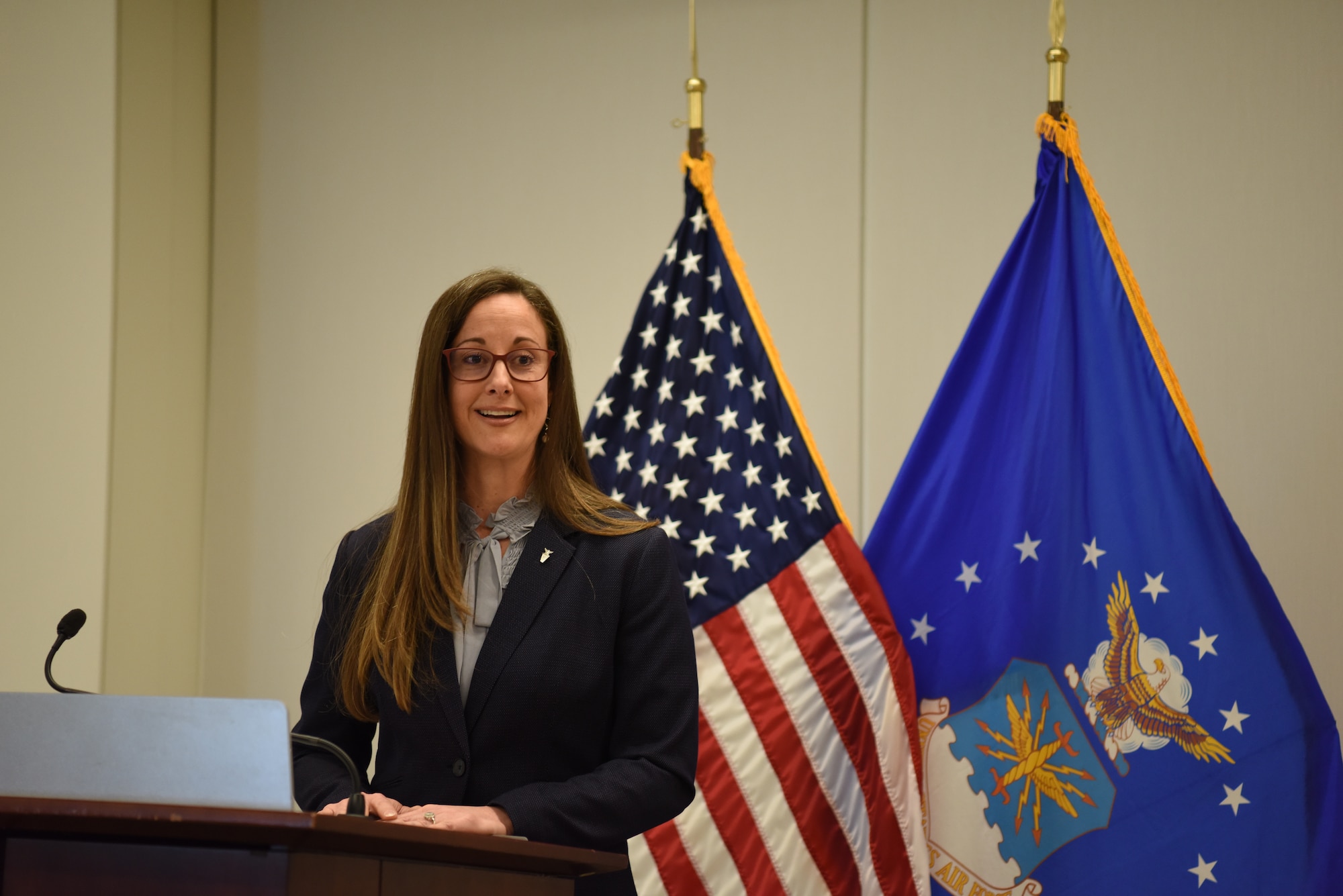 Image of a civilian talking at a podium.