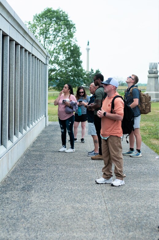 Soldiers with Headquarters and Headquarters Company, 166th Regiment Regional Training Institute scan the State of Pennsylvania Monument during an educational visit to Gettysburg National Military Park in Gettysburg, June 10, 2023. (U.S. Army National Guard photo by 1st Lt. Lindsey Boughter)