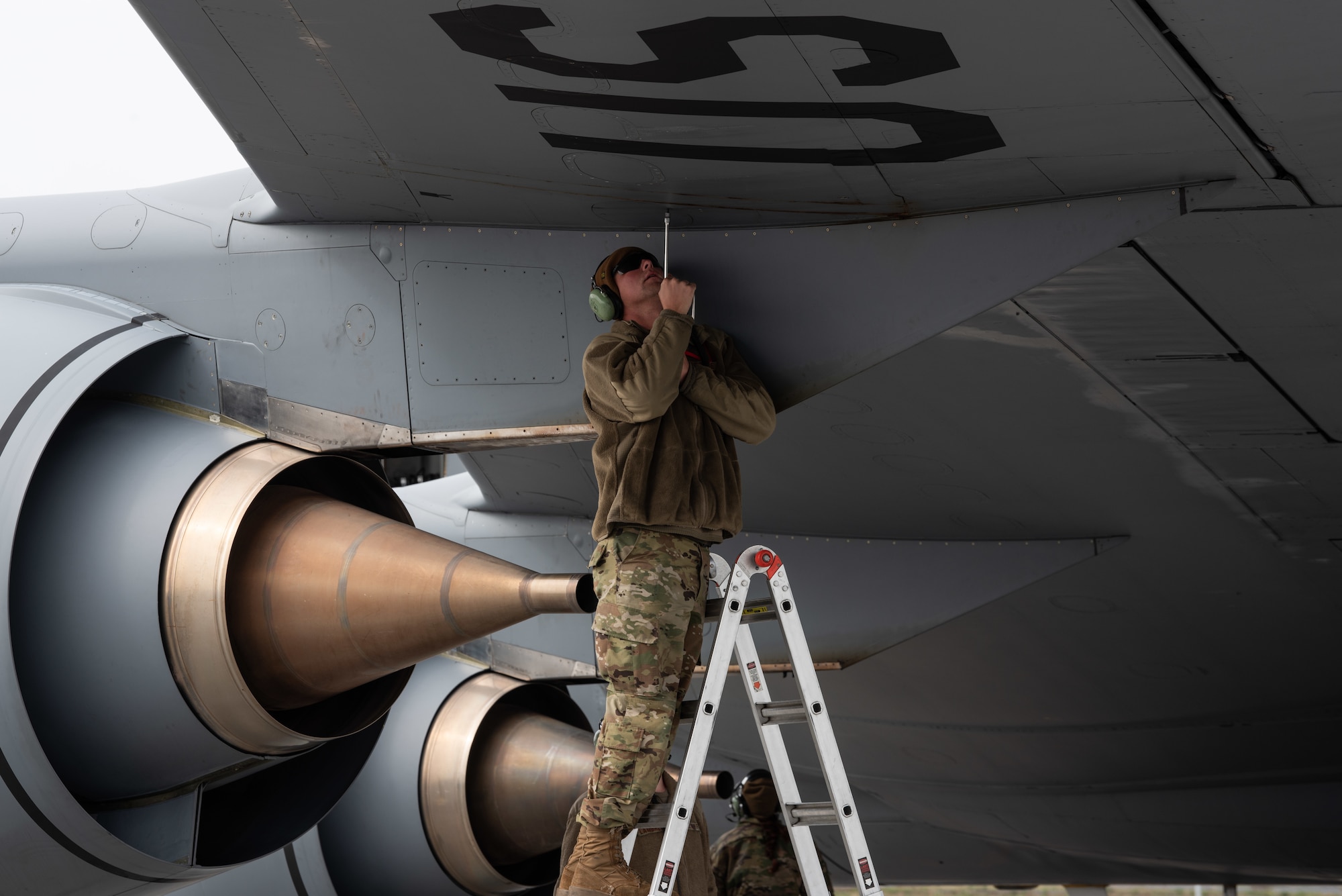 U.S. Air Force Tech. Sgt. Austin Bekkum, a crew chief assigned to the 128th Aircraft Maintenance Squadron, 128th Air Refueling Wing, Wisconsin National Guard, performs maintenance on a KC-135 Stratotanker wing as part of pre-flight procedures during exercise Air Defender 2023 at Keflavik Air Base, Iceland, June 2, 2023. Air Defender 2023, running June 12-23, is the largest air forces redeployment exercise since NATO was founded, integrating both U.S. and allied airpower to defend shared values, while leveraging and strengthening vital partnerships to deter aggression around the world. (U.S. Air National Guard photo by Master Sgt. Kellen Kroening)
