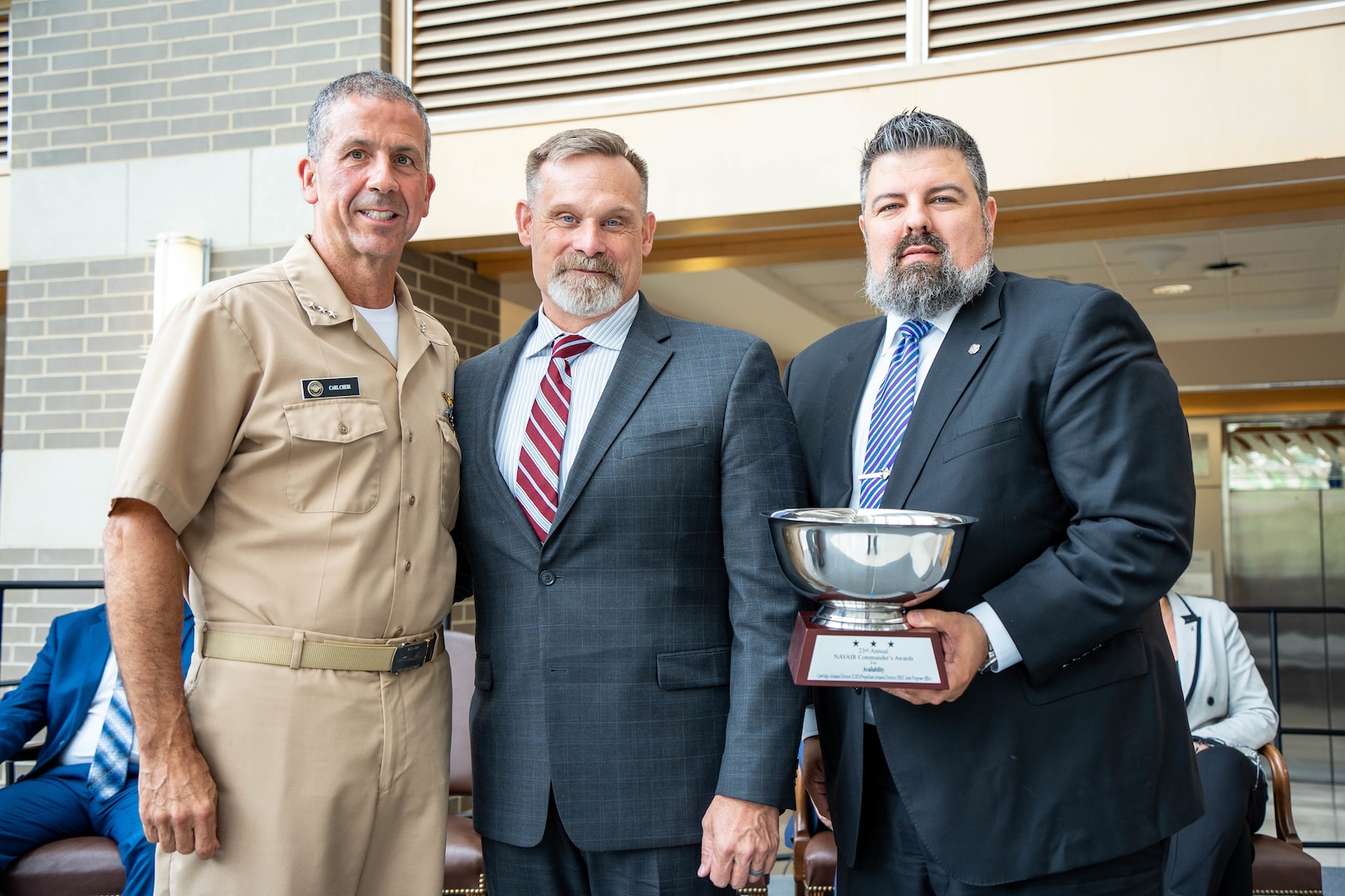NAVAIR Commander, Vice Admiral Carl Chebi (left) presented thee Naval Surface Warfare Center Indian Head Division Cartridge and Propellant Actuated Device (CAD/PAD) Joint Program Office (JPO) with the Naval Air Systems Command Commander’s Award for Availability during a ceremony at the Naval Air Station Patuxent River in Lexington Park, Maryland, May 31. CAD/PAD JPO Director Gregory Longworth (center) and JPO Navy Deputy Program Manager Jason Caron (right) received the award on behalf of the team of engineers, technicians, logisticians, analysts, handlers, drivers and radiographers from across the command who were responsible for the prestigious award.