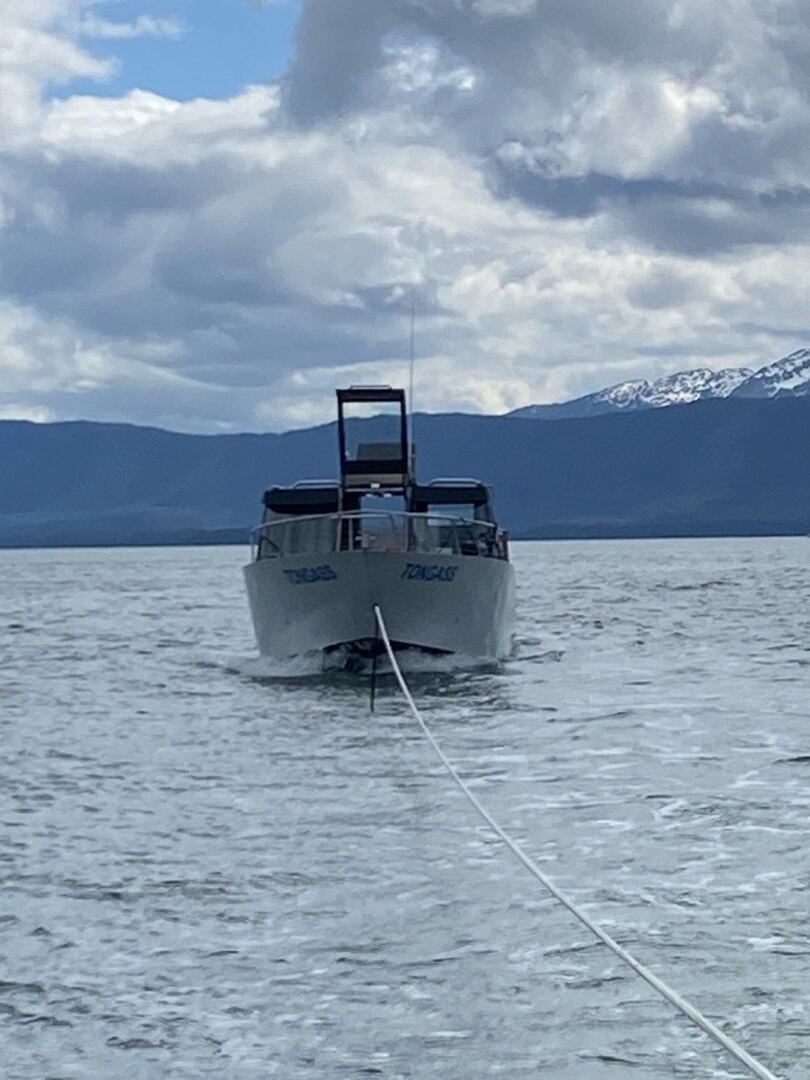 A 29-foot Response Boat-Small crew from Coast Guard Station Juneau tows 28-foot merchant vessel Tongass into Statter Harbor after the vessel caught fire in Auke Bay, Alaska, June 12, 2023.