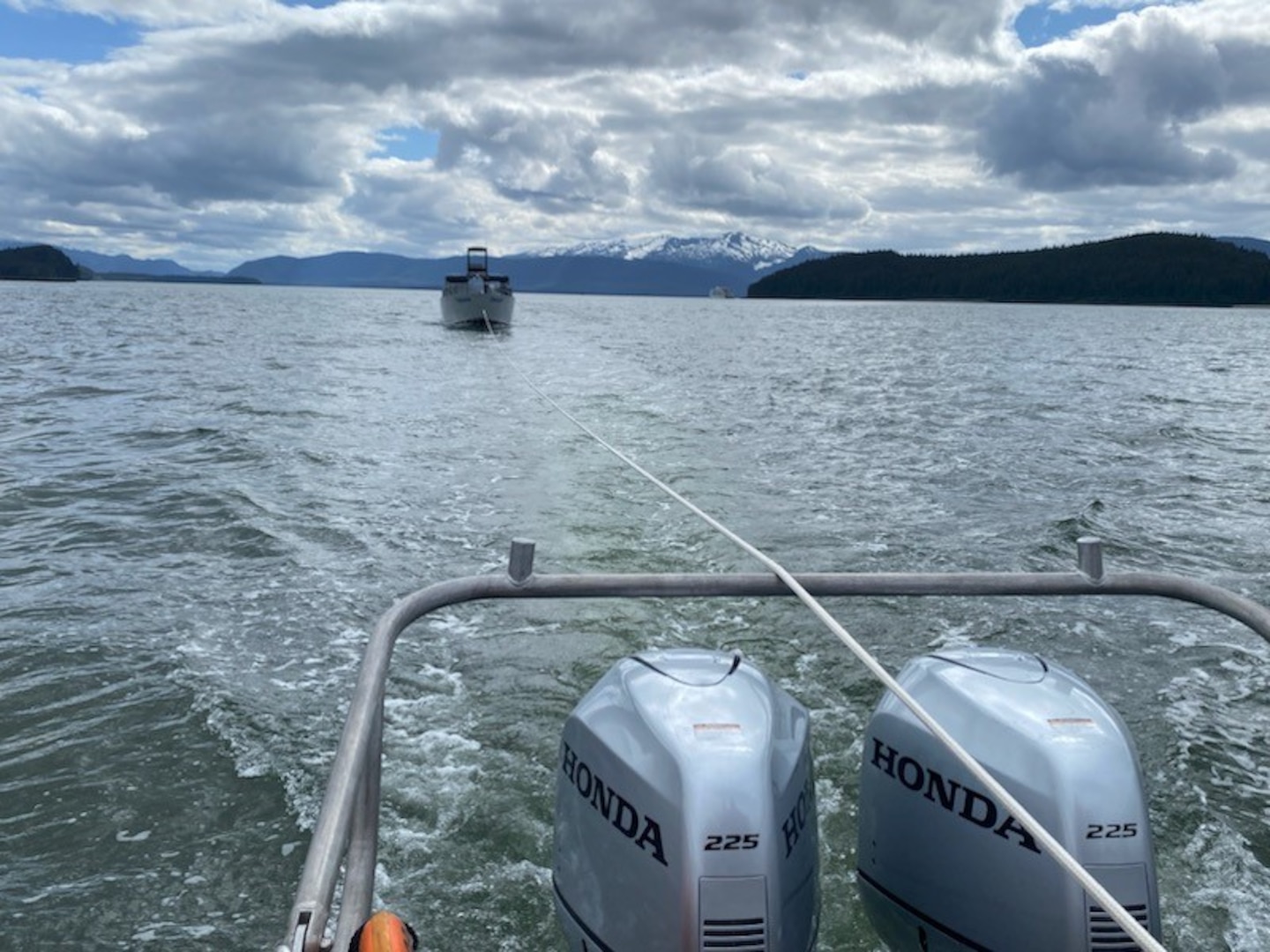 A 29-foot Response Boat-Small crew from Coast Guard Station Juneau tows 28-foot merchant vessel Tongass into Statter Harbor after the vessel caught fire in Auke Bay, Alaska, June 12, 2023.