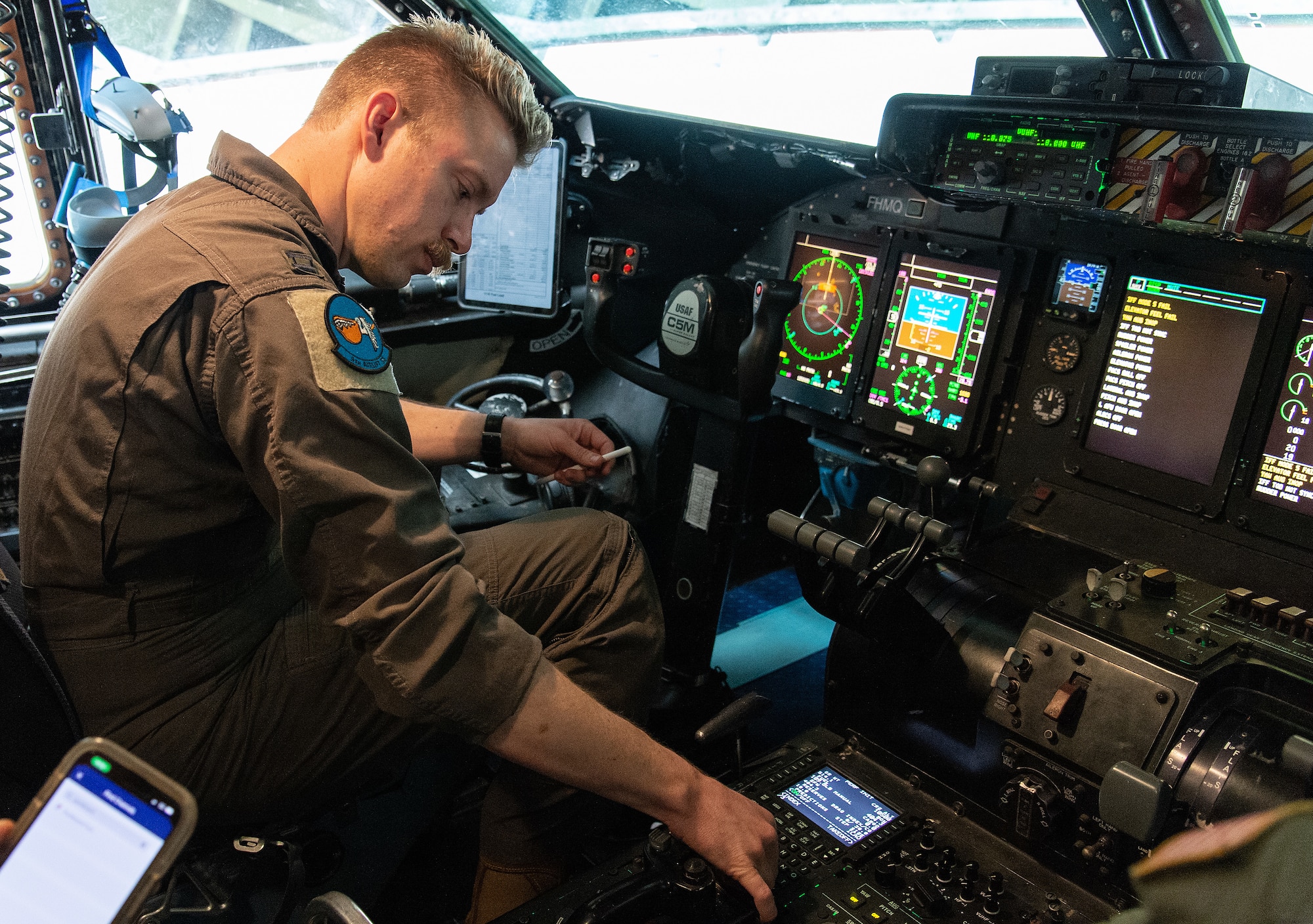 Capt. Shawn Moore, 9th Airlift Squadron pilot, programs data into the C-5M Super Galaxy flight computer prior to departure at Dover Air Force Base, Delaware, June 6, 2023. The base tested its ability to safely generate and launch aircraft on time during a hurricane evacuation exercise. (U.S. Air Force photo by Roland Balik)