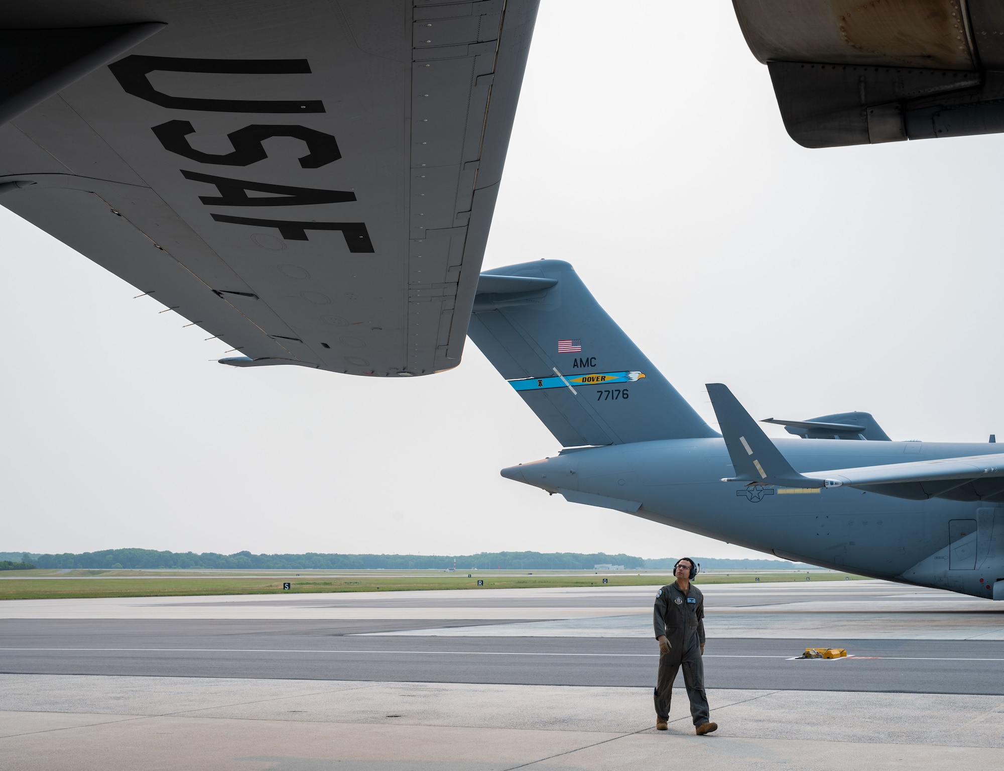 Lt. Col. Ryan Cox, 326th Airlift Squadron pilot, visually inspects the left wing of a C-17 Globemaster III as part of a preflight inspection during the 2023 hurricane evacuation exercise at Dover Air Force Base, Delaware, June 6, 2023. The C-17 was one of six Globemaster IIIs that departed Dover AFB during the hurricane evacuation exercise. (U.S. Air Force photo by Airman 1st Class Amanda Jett)