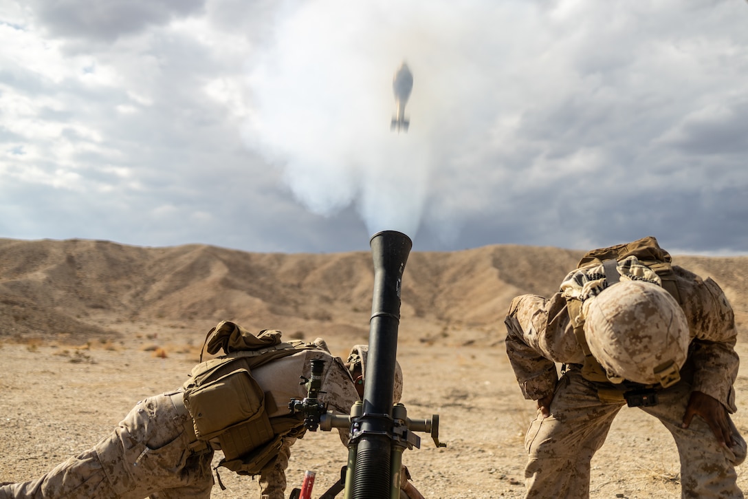U.S. Marine Corps Lance Cpl. Edward Reyes, left, and Lance Cpl. Daniel Puente, both mortarman with Weapons Company, 1st Battalion, 23D Marine Regiment, 4th Marine Division, conducts a mortar range during Integrated Training Exercise 4-23 at Marine Corps Air Ground Combat Center Twentynine Palms, California on June 12, 2023. As the Marine Corps Reserve’s premier annual training event, ITX provides opportunities to mobilize geographically dispersed forces for a deployment; increase combat readiness and lethality; and exercise MAGTF command and control of battalions and squadrons across the full spectrum of warfare. Reyes is a native of Fort Worth, Texas where he graduated from Fossil Ridge High School. Reyes’s civilian job is a firefighter. Puente is a native of Fort Worth, Texas where he graduated from Harlandale High School. Puente’s civilian job is salesman.
