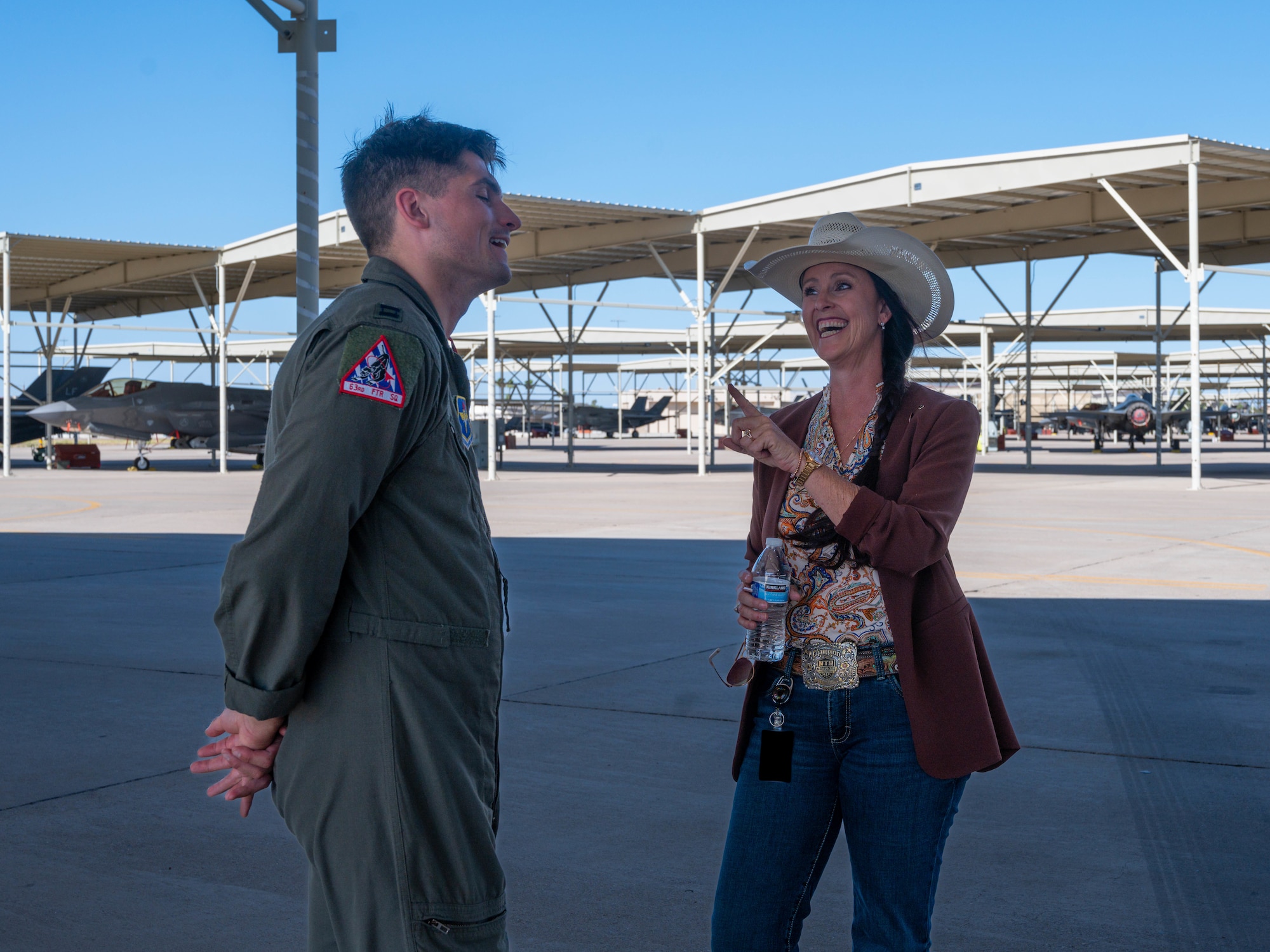 Arizona state Sen. Janae Shamp, Arizona district 29 senator, tells a story to U.S. Air Force Capt. Zachariah Mertes, 63rd Fighter Squadron instructor pilot, June 9, 2023, at Luke Air Force Base, Arizona.