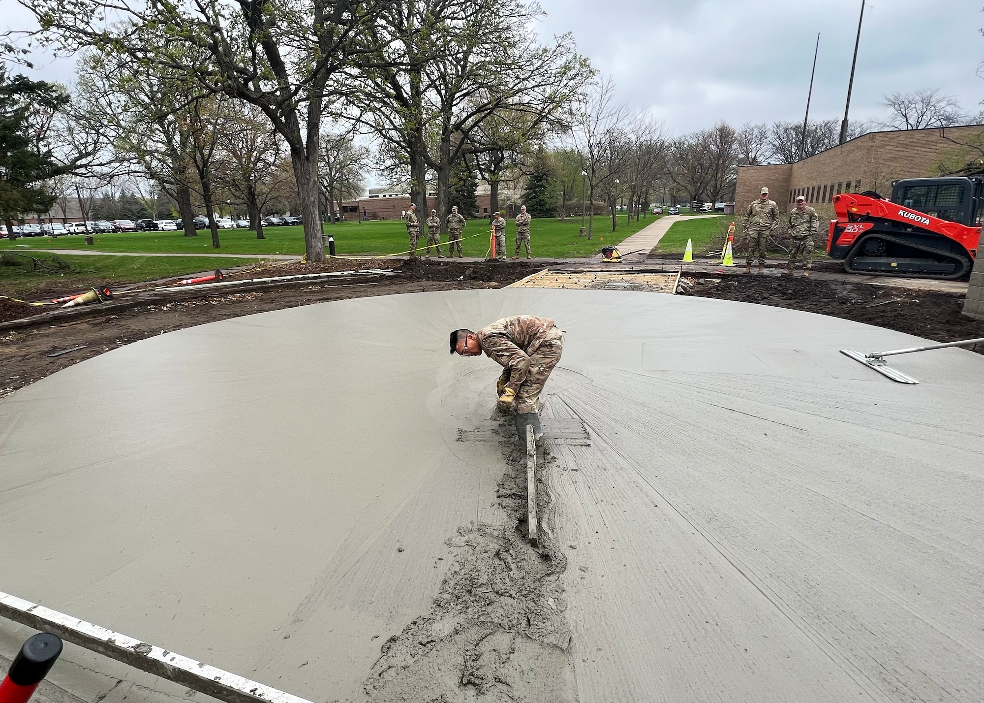 U.S. Air Force Airmen from the 133rd Civil Engineer Squadron pour concrete in front of the 133rd Operations Group building in St. Paul, Minn., May 5, 2023.