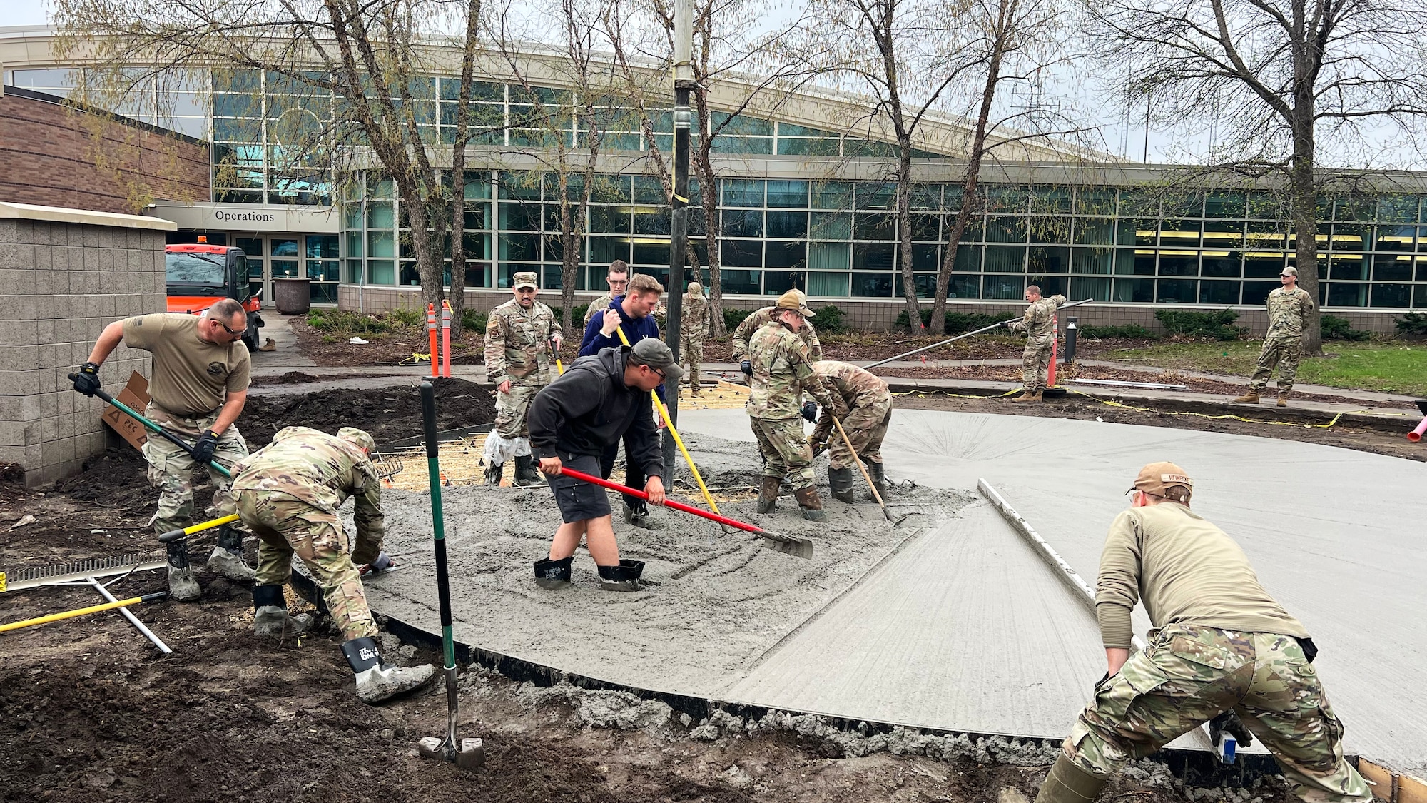 U.S. Air Force Airmen from the 133rd Civil Engineer Squadron pour concrete in front of the 133rd Operations Group building in St. Paul, Minn., May 5, 2023.