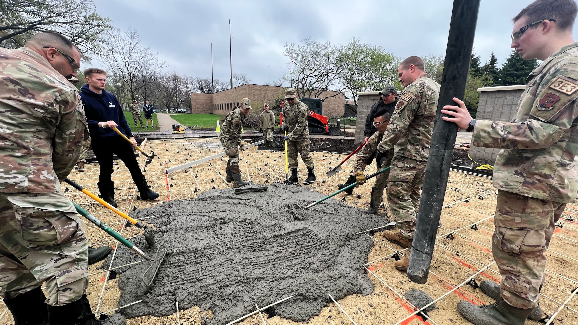 U.S. Air Force Airmen from the 133rd Civil Engineer Squadron pour concrete in front of the 133rd Operations Group building in St. Paul, Minn., May 5, 2023.