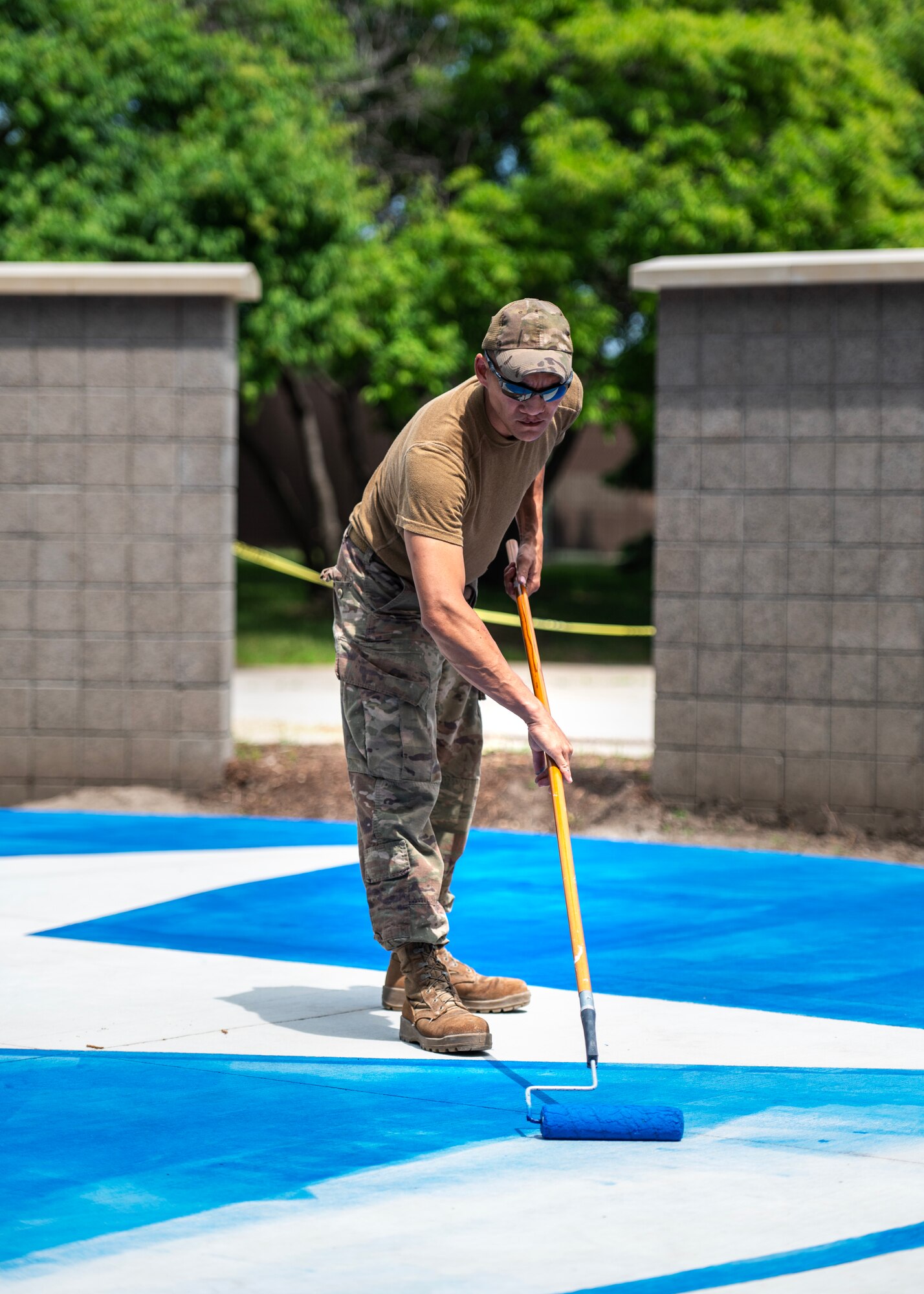 U.S. Air Force Tech. Sgt. Mark Spitznogle, 133rd Civil Engineer Squadron, stains the concrete pad in front of the 133rd Operations Group building in St. Paul, Minn., June 3, 2023.