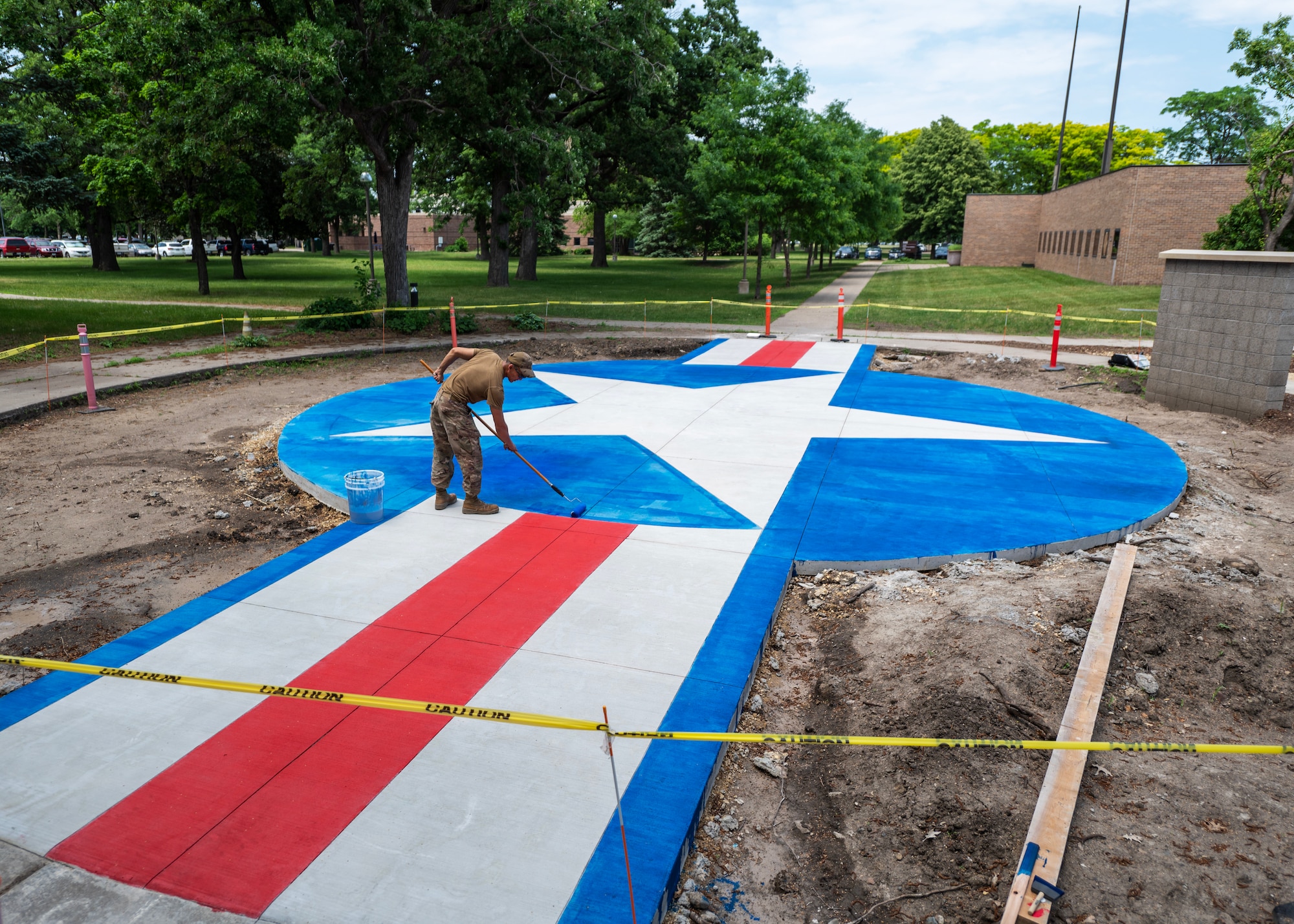 U.S. Air Force Tech. Sgt. Mark Spitznogle, 133rd Civil Engineer Squadron, stains the concrete pad in front of the 133rd Operations Group building in St. Paul, Minn., June 3, 2023.